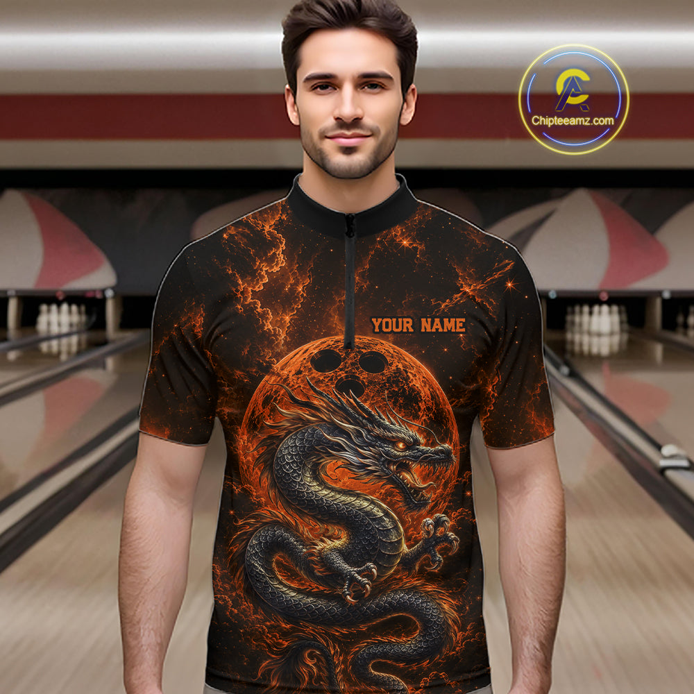Front view of a male model in a bowling alley wearing an orange custom quarter-zip bowling shirt featuring an ancient dragon, flames, and a moon-inspired bowling ball design.