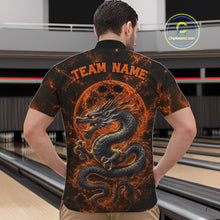 Load image into Gallery viewer, Back view of a male model in a bowling alley wearing an orange custom quarter-zip bowling shirt featuring an ancient dragon, flames, and a moon-inspired bowling ball design.