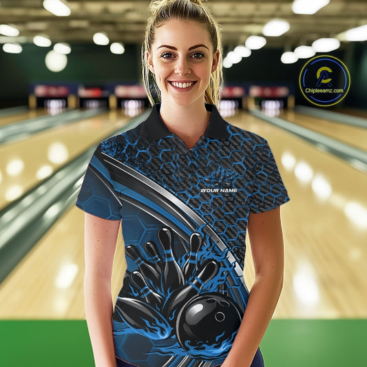 Female model in a bowling lane wearing a black and blue polo shirt with honeycomb texture and a dynamic flame bowling strike illustration.