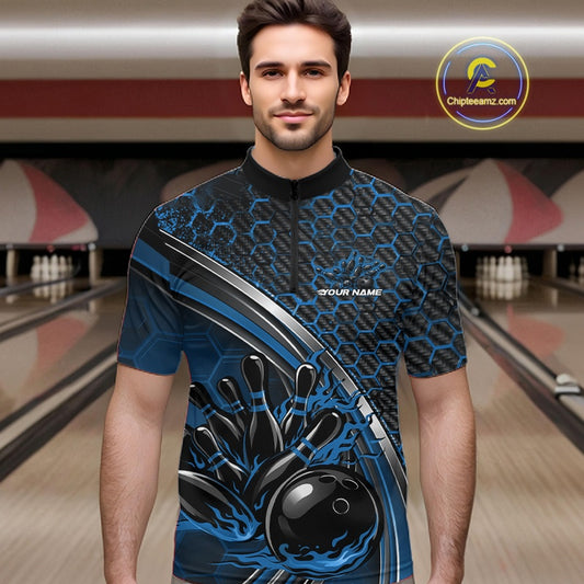 Male model in a bowling lane wearing a black and blue quarter zip shirt with honeycomb texture and a flaming bowling ball hitting pins graphic.
