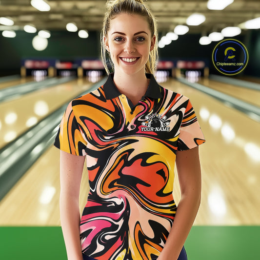 Woman wearing a colorful bowling shirt with a logo in a bowling alley.