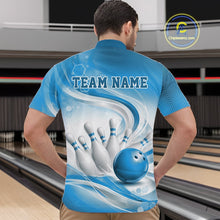 Load image into Gallery viewer, Male model standing in a bowling lane wearing a white and blue bowling quarter-zip shirt featuring abstract wave lines and a glossy bowling ball striking pins on the front.