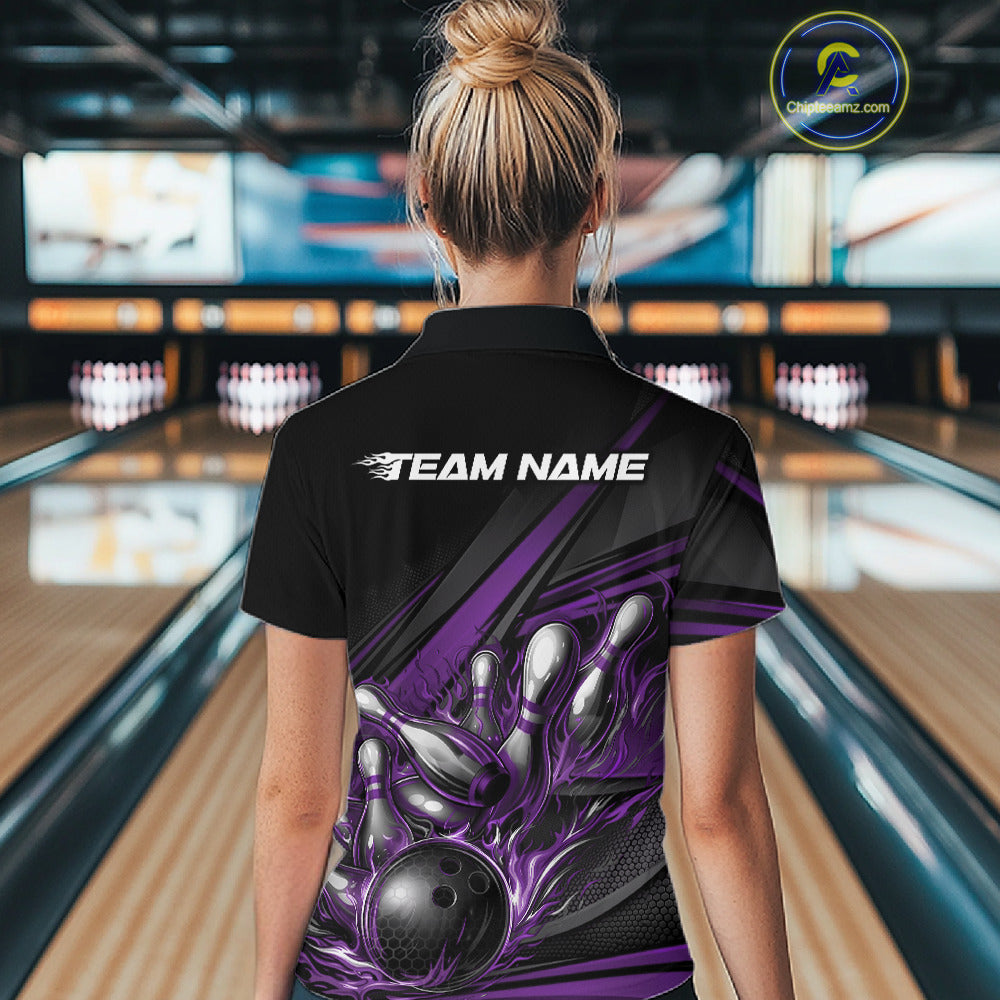 Female model at a bowling venue, back view of black polo shirt showcasing purple flame bowling ball and abstract stripe design