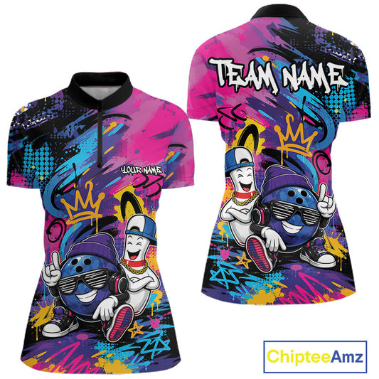 Front and back views of a women's short-sleeve quarter zip shirt with a colorful graffiti-style graphic featuring two cartoon bowling balls, a crown, and the text 'TEAM NAME' on the back. The shirt has a black collar and cuffs, and a multicolor print with pink, blue, purple, yellow, and black splashes.