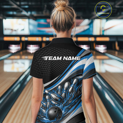 Back view female model in black and blue quarter zip bowling shirt in bowling lane, flame bowling ball and pins sports themed design