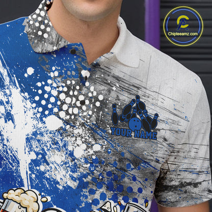 Close-up view of the left chest of a blue and white grunge splatter polo shirt showing humorous bowling ball and pin fist-fighting artwork detail.