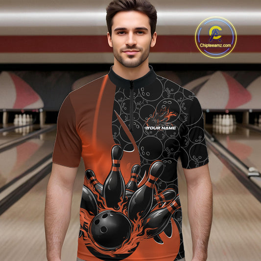 Male model front view at bowling lane wearing black and orange quarter zip shirt with flaming bowling ball design and energetic bowling strike graphics