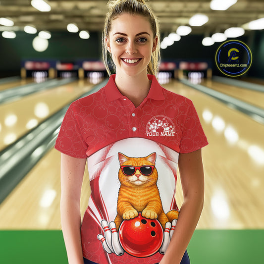 Female model at a bowling lane wearing a white and red bowling polo shirt with an orange British Shorthair cat and bowling ball artwork.