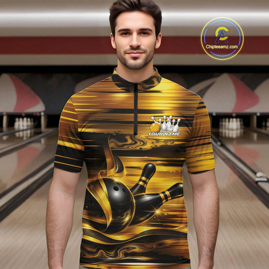 Front view of a male model inside a bowling center wearing a bowling quarter-zip shirt with glossy gold and black bowling ball and pins graphics.