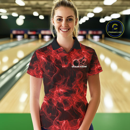 Female model at the bowling lane wearing a red bowling polo with fiery bowling ball artwork.