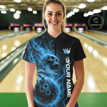 Load image into Gallery viewer, Female model wearing a black bowling quarter-zip shirt in a bowling alley featuring a skull clutching a bowling ball surrounded by swirling blue energy flames