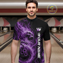 Load image into Gallery viewer, Male model wearing a black bowling quarter-zip shirt in a bowling alley featuring a skull clutching a bowling ball with swirling purple energy flames