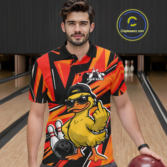 Male model at a bowling alley wearing a black and orange polo featuring a duck in sunglasses and cap with geometric details.
