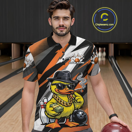 Male model at the bowling lane wearing a black and orange bowling polo with duck-themed bowling artwork and pin graphics.