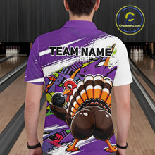 Load image into Gallery viewer, Back view of a male model wearing a purple custom bowling polo shirt featuring a funny graffiti style turkey holding a bowling ball, paint splatter details, and a custom name in a bowling alley.