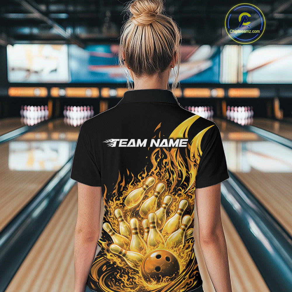 Back view in bowling lane showing female model wearing black and yellow bowling quarter zip featuring flaming bowling ball striking pins with fiery action graphics.