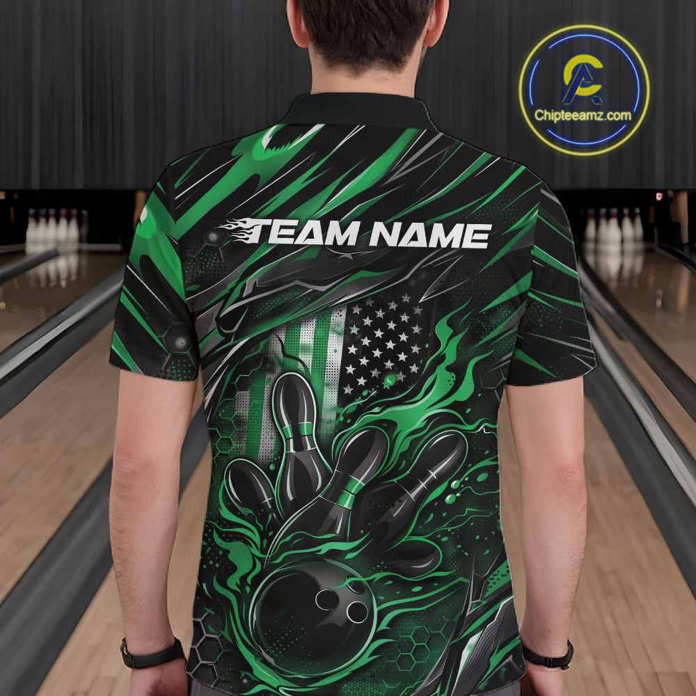 Back view of a male model in a bowling center wearing a black and green polo shirt featuring a flaming bowling ball and patriotic pin design.