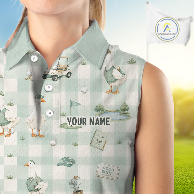 A sleeveless collared polo shirt with a light green and white gingham pattern, decorated with watercolor illustrations of ducks, golf balls, a golf cart, and golf course scenery. The shirt features a customizable name placeholder 'YOUR NAME' in the center.