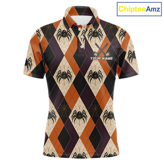 A short-sleeve polo shirt with a Halloween-themed argyle pattern featuring spiders, webs, and orange, black, and beige diamonds. The shirt has a white collar, a three-button placket, and 'YOUR NAME' printed on the chest alongside crossed golf clubs.