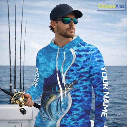 Angler wearing Sailfish fishing blue ocean camouflage performance long sleeve hooded fishing shirt on the water