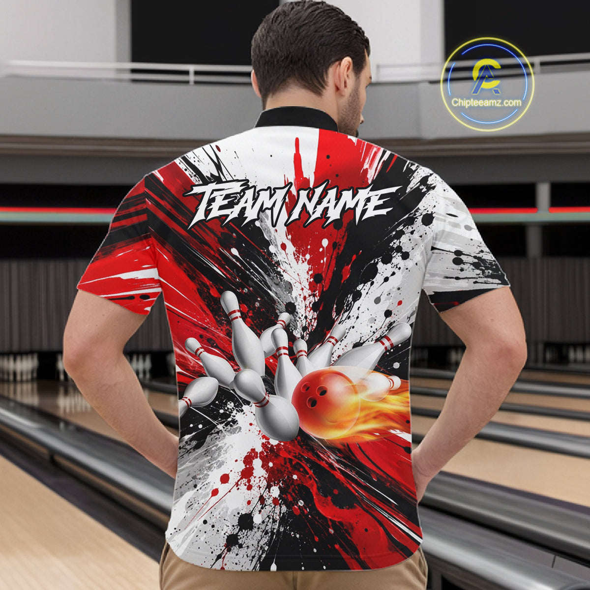 Back view of man wearing a red splatter bowling quarter zip shirt in a bowling alley.