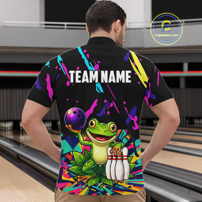 Person wearing a colorful bowling-themed shirt with a frog design in a bowling alley.