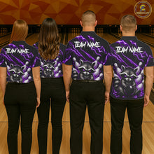 Load image into Gallery viewer, Back view of bowling team wearing matching purple neon raccoon bowling shirts in a bowling alley.