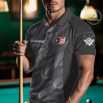 Man wearing a metal grey American flag 8 ball billiard jersey beside a pool table front view.