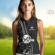 Load image into Gallery viewer, Woman wearing a black sleeveless golf shirt with a cartoon golf ball design on a golf course background