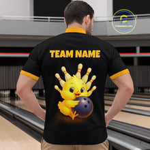 Load image into Gallery viewer, Person wearing a black shirt with a yellow chick holding a bowling ball design and 'TEAM NAME' text, in a bowling alley.